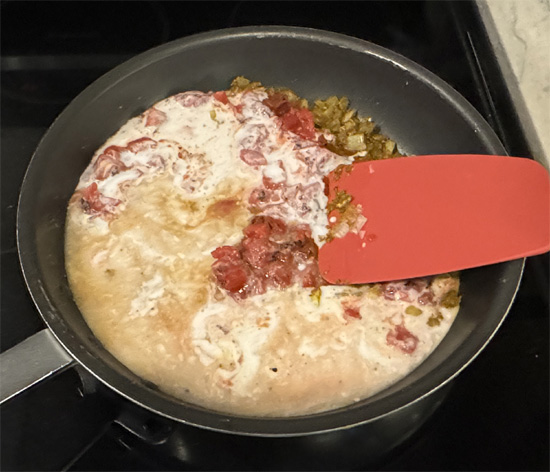 Pour in the tomatoes, coconut milk, vegetable broth (or water) and lentils.