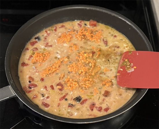 Pour in the tomatoes, coconut milk, vegetable broth (or water) and lentils.