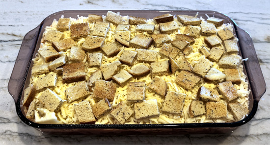 Spread remaining bread cubes over the top. 