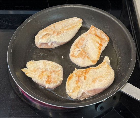 Flip the chicken breasts over, reduce the heat to medium and add 1/3 cup of chicken broth. Cover and cook for another 6-8 minutes until done. It's best to use a meat thermometer and make sure the internal temperature has reached 165 degrees Fahrenheit. 