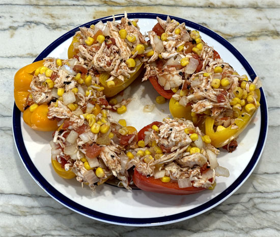 Use the chicken mixture to fully overstuff the bell peppers. There will be shredded chicken left over, set it and the stuffed peppers aside.