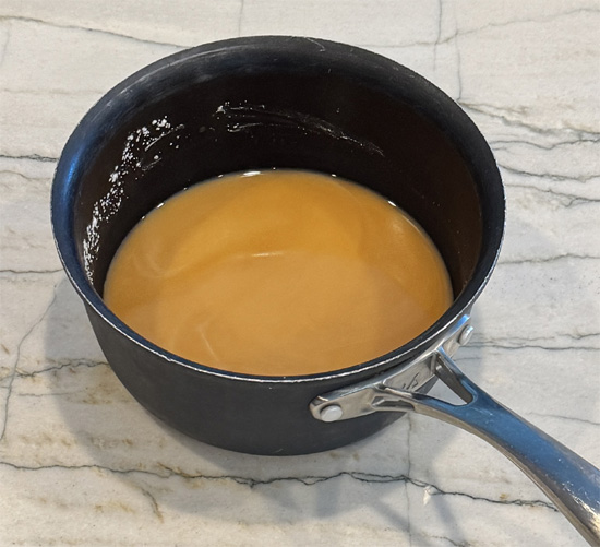 Combine the chicken broth, oyster sauce and soy sauce in a small saucepan and bring to a boil.
