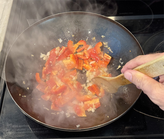 Add the red bell pepper. Stir and cook for 1 minute.