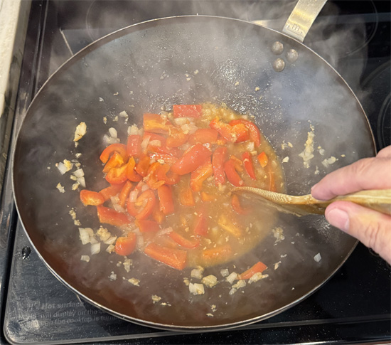 Pour in half of the stir fry sauce. Add the sugar snap peas and broccoli. Stir and cook for 1 minute.
