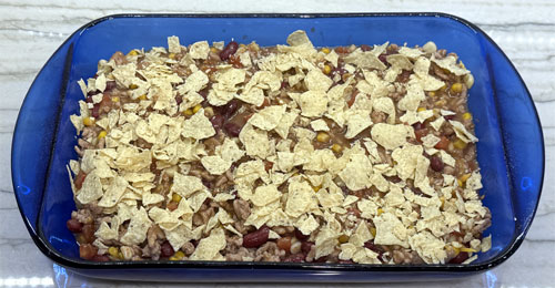 Spread the crushed tortillas evenly next.