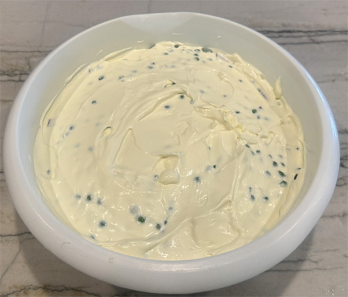 Whisk together the next three ingredients: mayonnaise, sour cream, and Splenda. Then, spread the mixture over the top.