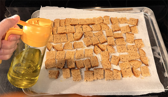 Cut the bread into small 1 inch squares. Spread the bread squares on the prepared baking sheet. Spray with olive oil and sprinkle with 1 Tbsp Everything Bagel seasoning. Bake 8 minutes, flip, spray again, and bake another 8 minutes until crunchy. Set croutons aside.
