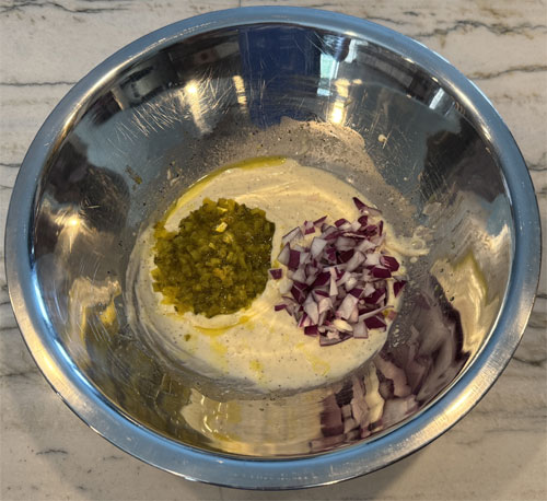 In a large mixing bowl, whisk together the mayonnaise, Dijon mustard, apple cider vinegar, honey, celery, onion, dill relish, dill, salt, and pepper. Taste and adjust seasonings as needed—add more vinegar for tang, more mustard for zing, or more honey to mellow the flavors.