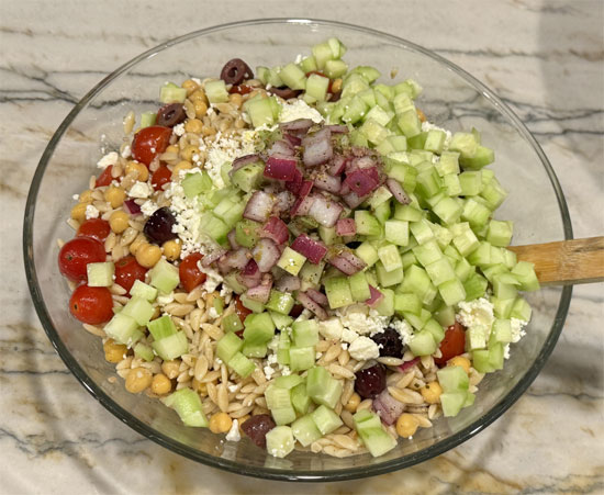 After cooling, add feta, cucumbers, parsley, mint, dill, and the remaining dressing. Toss to combine and serve.