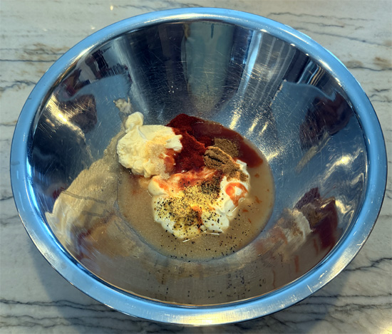 In a separate bowl, whisk together the Greek yogurt, mayonnaise, lime juice, honey, hot sauce, lemon pepper, garlic powder, paprika, and cumin until smooth.