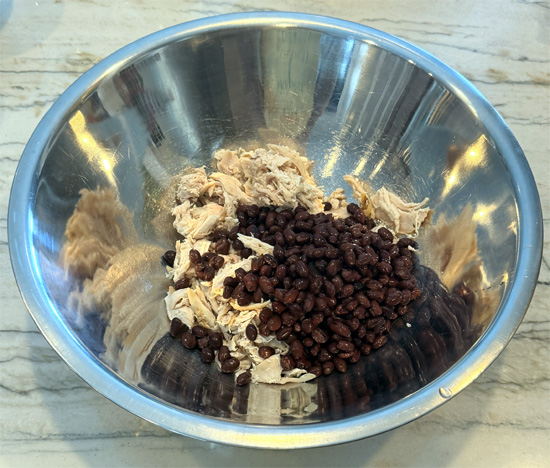 Place the chicken, black beans, corn, red onion, bell peppers and cilantro in a large mixing bowl.