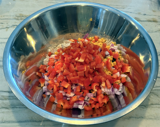 Place the chicken, black beans, corn, red onion, bell peppers and cilantro in a large mixing bowl.