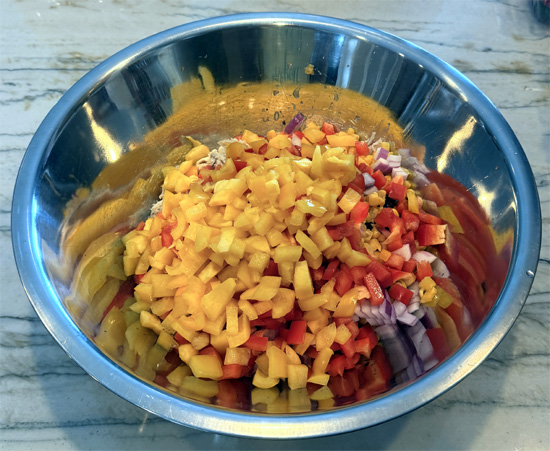 Place the chicken, black beans, corn, red onion, bell peppers and cilantro in a large mixing bowl.