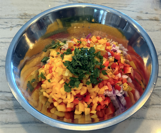 Place the chicken, black beans, corn, red onion, bell peppers and cilantro in a large mixing bowl.