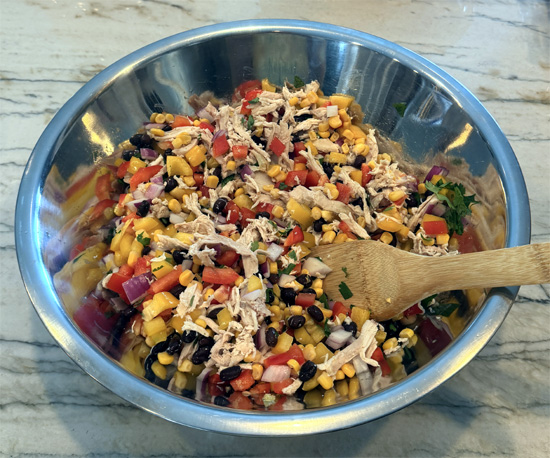 Place the chicken, black beans, corn, red onion, bell peppers and cilantro in a large mixing bowl.