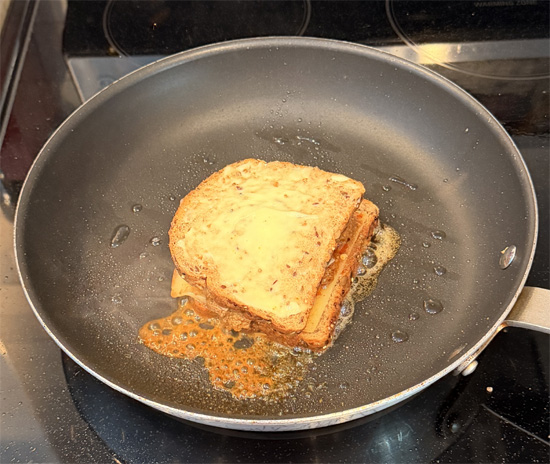 Build the sandwich: Place one slice of bread mayo-side down in the pan. Top with the cheese, then the birria meat, and finally the second slice of bread mayo-side up.