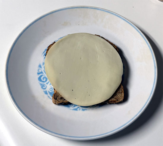 Assemble the sandwich: one slice of bread butter side down, a slice of provolone, 2 tablespoons marinara, the chicken patty, 2 more tablespoons marinara, the second slice of provolone, and the last slice of bread butter side up.