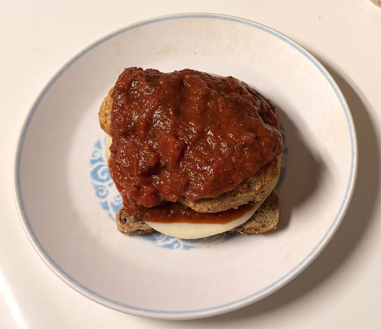 Assemble the sandwich: one slice of bread butter side down, a slice of provolone, 2 tablespoons marinara, the chicken patty, 2 more tablespoons marinara, the second slice of provolone, and the last slice of bread butter side up.