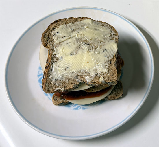 Assemble the sandwich: one slice of bread butter side down, a slice of provolone, 2 tablespoons marinara, the chicken patty, 2 more tablespoons marinara, the second slice of provolone, and the last slice of bread butter side up.