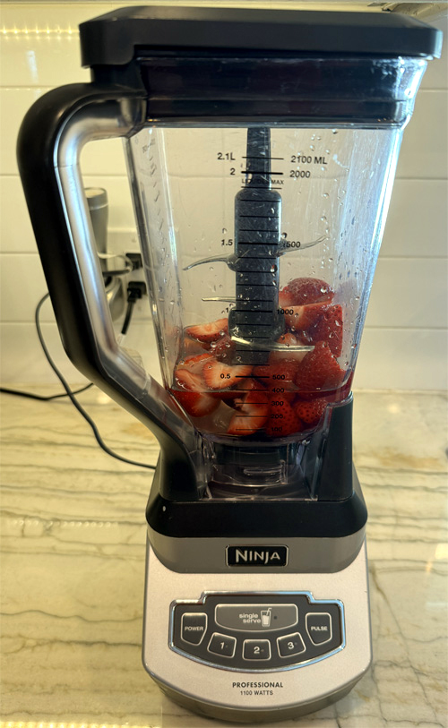 Trim the strawberries and put them in a blender with a cup of coconut water. Blend until strawberries are thoroughly pureed, about 30-60 seconds.
