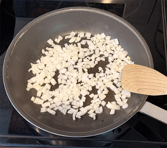 Heat a large oven-safe frying pan over medium heat. After 2 minutes, add the olive oil and onions. Sauté them for about 5 minutes.