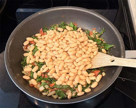 Stir in the cannellini beans and pasta sauce.