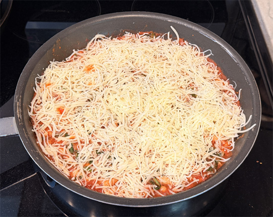 Turn off the heat under the frying pan. Mix together the two mozzarella cheeses. Then sprinkle that cheese over top the beans.