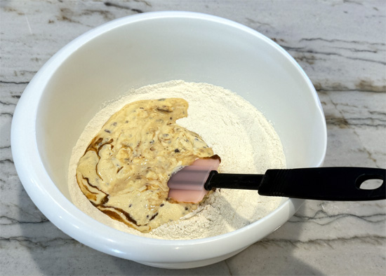 Add ice cream. Pour the entire pint of melted ice cream into the dry ingredients. Stir gently until just combined. Don't overmix.