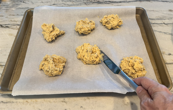 Shape the scones. Using a knife or large spoon, divide dough into 6 portions and place on the prepared baking sheet. The dough will be sticky, so don't worry about perfect shapes.