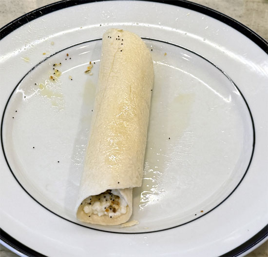 Roll the tortilla tightly, then brush the outside with olive oil.
