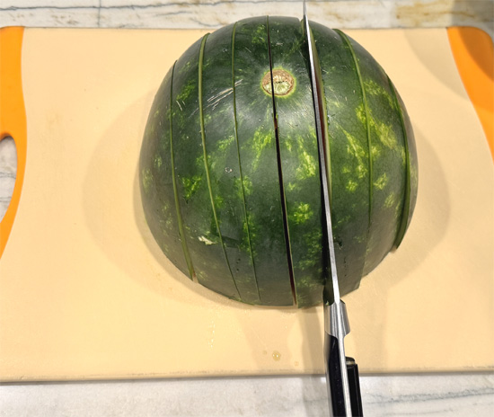 Place one half cut-side down on your cutting board. With a sharp, large knife, cut it into evenly spaced slices about 1 1/2 inches wide. You’re making big “fingers.”