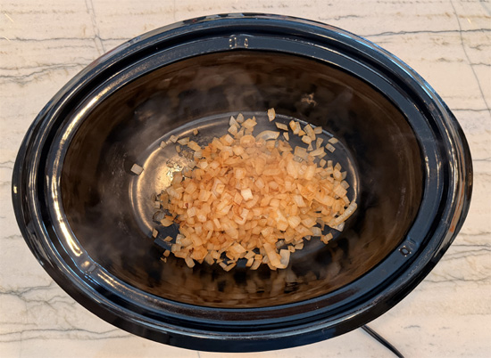 Place the chicken, condensed soup, onion and butter in a large slow cooker. Add the bone broth to cover and stir well. 