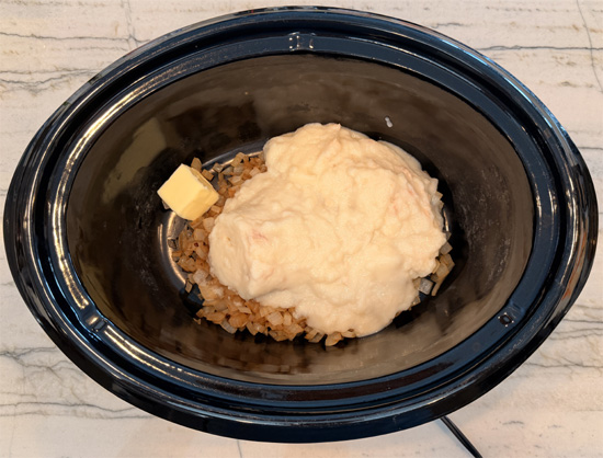 Place the chicken, condensed soup, onion and butter in a large slow cooker. Add the bone broth to cover and stir well. 