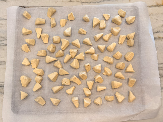 Cut each biscuit into 8 small pieces and place the dough on a parchment lined baking sheet. Bake them for 8-10 minutes, until lightly browned.