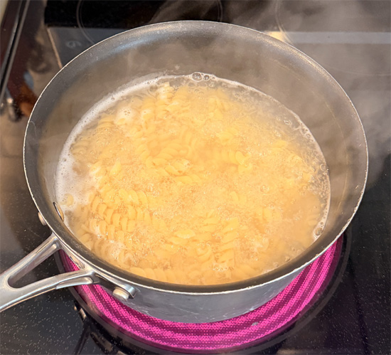 Add the pasta to the boiling water, stir, and return it to a rapid boil. Reduce the heat to medium and cook uncovered, stirring occasionally, 11 to 13 minutes.