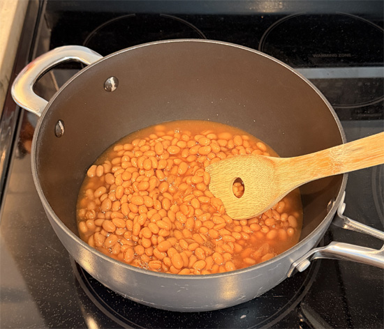 Return the empty pot to medium heat. Add the beans and tomatoes and heat about 3 minutes, until steaming.