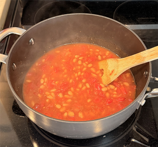 Return the empty pot to medium heat. Add the beans and tomatoes and heat about 3 minutes, until steaming.
