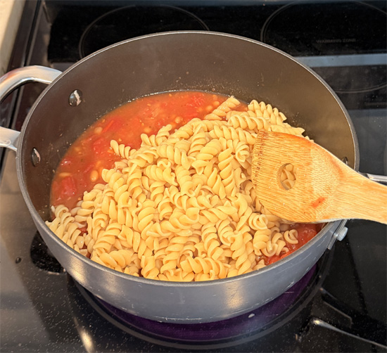 Stir in the pasta and hot dog pieces. Keep heating and stirring until everything is hot all the way through. Divide into 4 servings for a meal or 8 servings for a side dish.