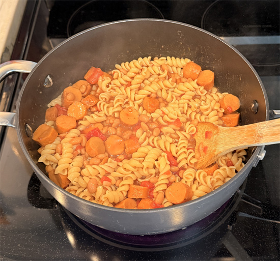 Stir in the pasta and hot dog pieces. Keep heating and stirring until everything is hot all the way through. Divide into 4 servings for a meal or 8 servings for a side dish.