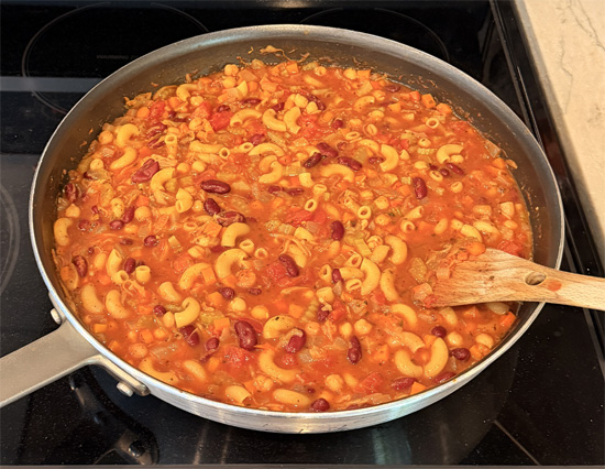 Mix in the macaroni, raise heat to medium and cook for an additional 12-15 minutes, until macaroni is done and vegetables are tender. 