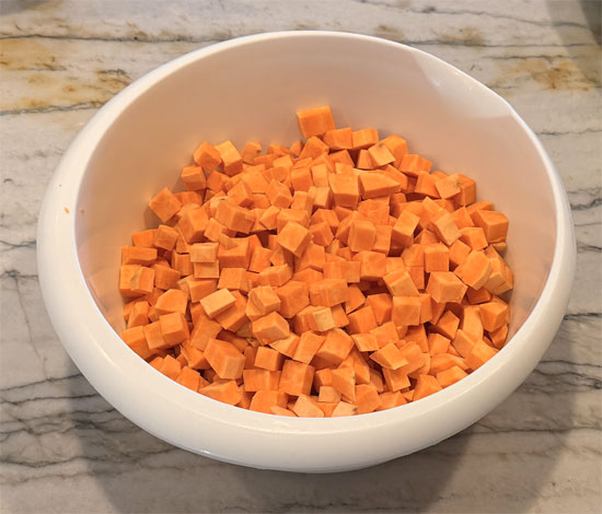 Heat a large pot or pan over medium heat. Add olive oil, sweet potatoes, and onion. Cook, stirring occasionally, until onions become tender, about 8 to 10 minutes.