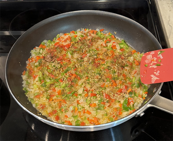 Stir in the fennel, chili pepper, black pepper and salt to the onion mixture.