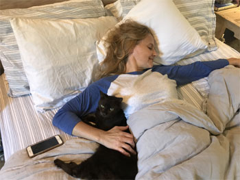 Leigh and her cat Erie May napping away.