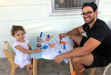 Albert with his daughter Aria on a play date decorating a kite.